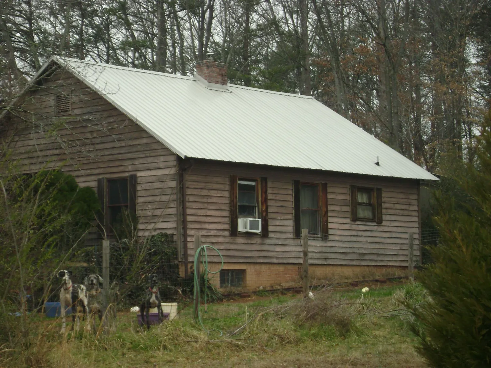 White metal roof on an old wood sided farmhouse, from a Metal Roof Installation job in Saratoga